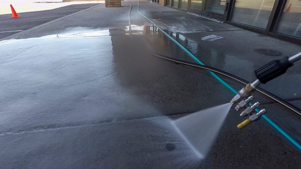 gum being cleaned off concrete
